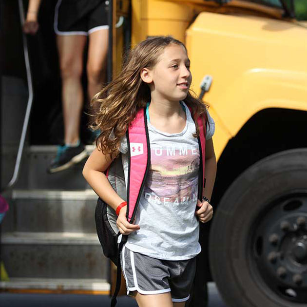 Girl getting of bus at BT Camps in Reisterstown. facility